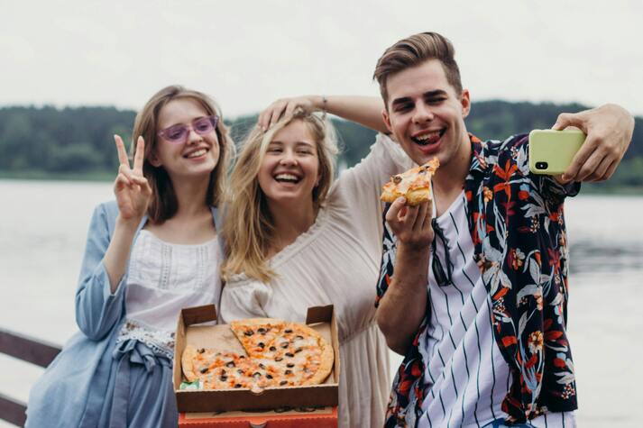 Young people enjoying pizza