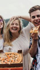 Young people enjoying pizza